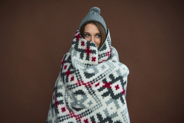 image of a woman feeling cold because of a broken boiler