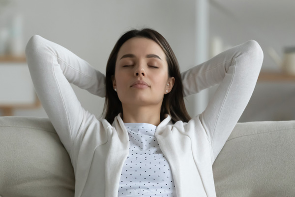 image of a woman enjoying her ductless mini-split