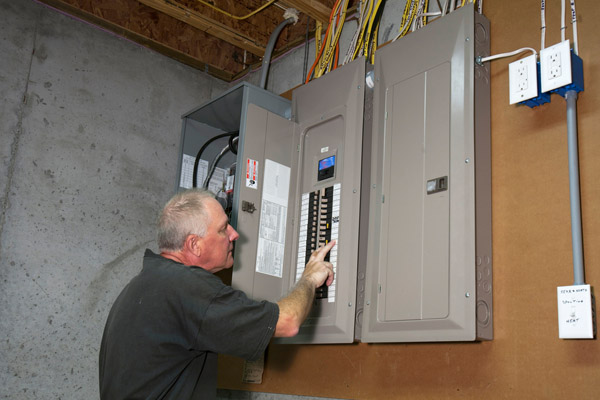 image of homeowner at circuit breaker box after furnace blows circuit