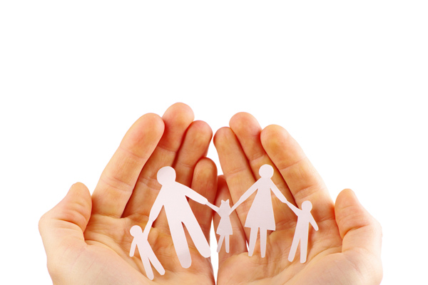 image of paper cut out of family in hands depicting heating safety
