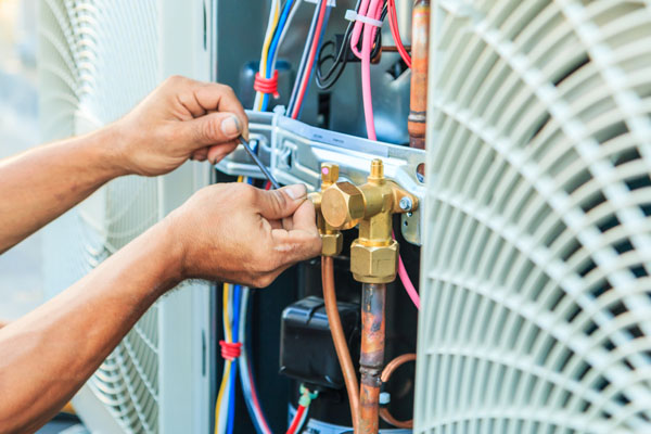 image of an hvac contractor performing air conditioner installation