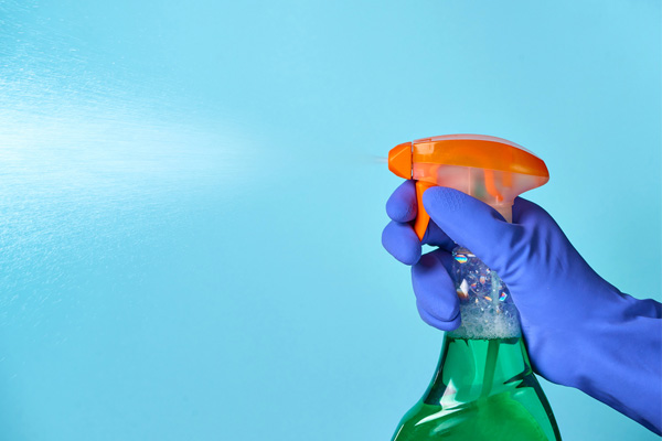 image of homeowner using disinfectant to clean hvac ductwork