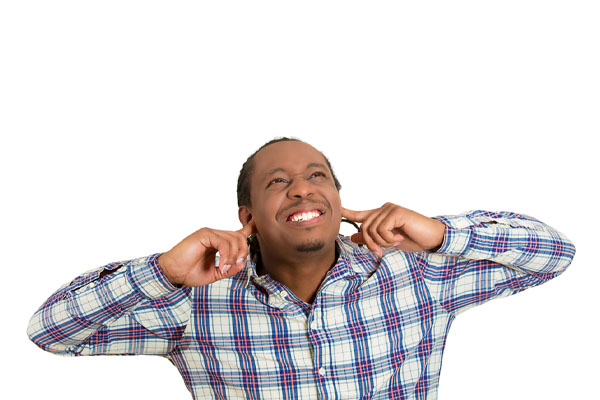 image of a homeowner covering ears due to AC unit making noise.