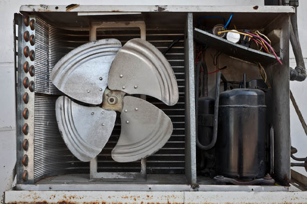 image of an old corroded air conditioner condensing unit