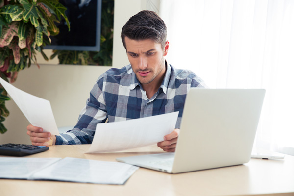 image of a homeowner reviewing energy bills depicting heating and air conditioning