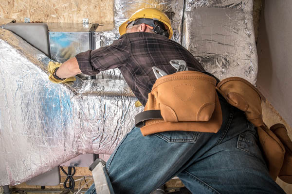 image of an hvac contractor repairing hvac ductwork due to leaks