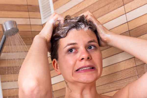 image of a homeowner taking a cold shower due to no domestic hot water and boiler