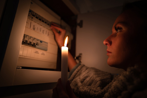 image of a homeowner during power outage and gas furnace