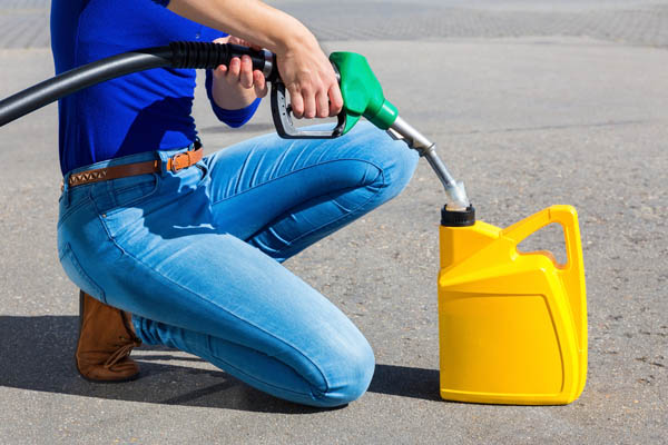 image of a woman filling a diesel gas can due to an empty heating oil tank