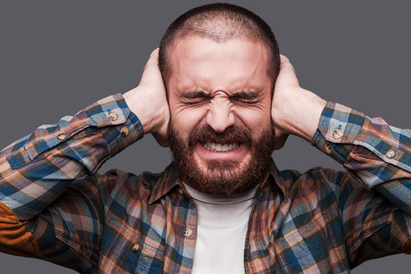 image of a homeowner covering ears due to ductwork making noise