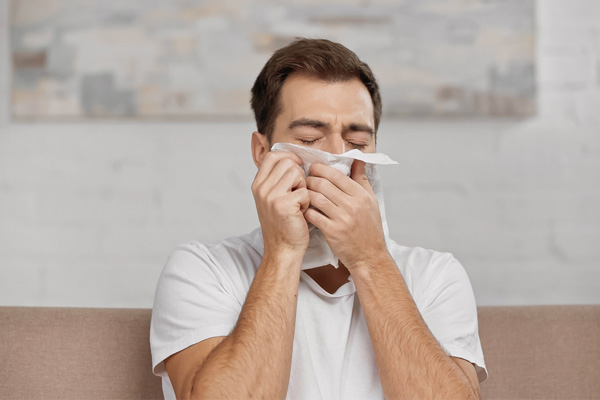 image of a homeowner sneezing due to hvac allergies
