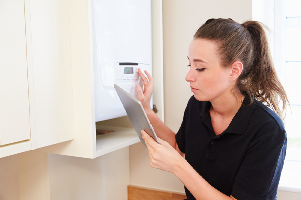 image of homeowner adjusting boiler temperature