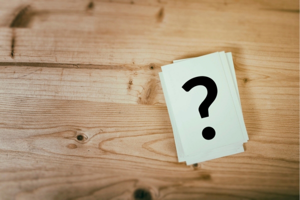 question mark on a stack of paper depicting HVAC Service Myths FAQs