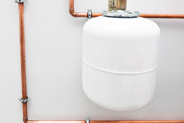 image of copper pipes and expansion tank in boiler room