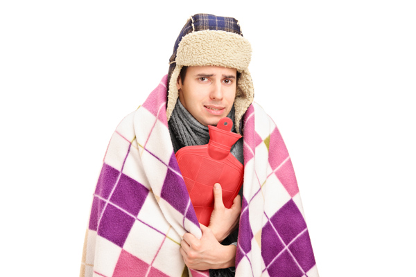 image of a homeowner feeling chilly due to improper furnace sizing and home heating