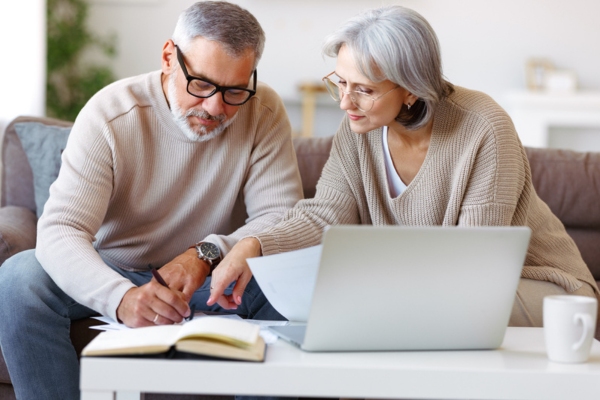 couple evaluating energy bill after home air sealing