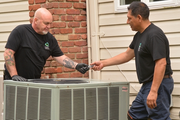 Hart Home Comfort HVAC technicians servicing an air conditioner