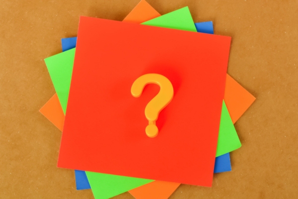 question mark on colored paper depicting FAQs about What To Do When Your AC Unit Freezes Up