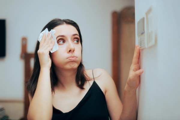 woman feeling warm during summer due to faulty thermostat