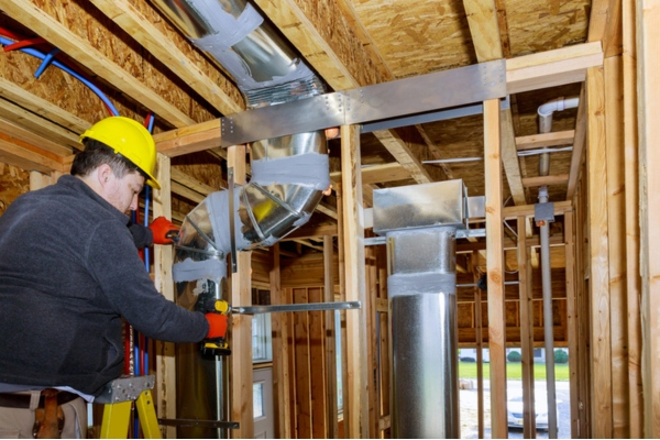 HVAC technician attending to HVAC ducts