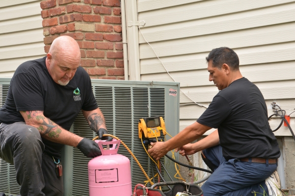 Hart Home Comfort HVAC staff refilling AC refrigerant