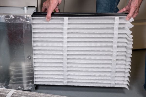 homeowner changing home HVAC air filter