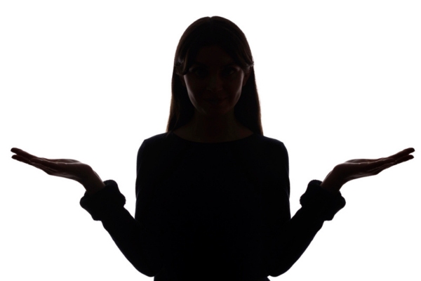 image of a young girl thinking and comparing with hands raised on the each side