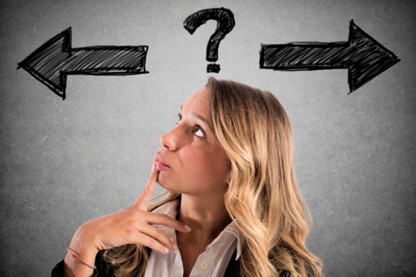 woman looking up while thinking with arrows pointing on different side and question mark doodles depicting Choosing an Energy-Efficient Heating System