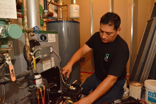 Hart Home Comfort HVAC technician tending to a boiler