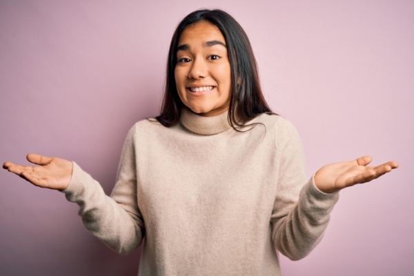 woman shrugging with hands on the side depicting where does Oil Tank Water Issues come from