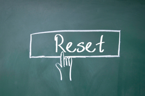 finger click reset symbol doodled on a chalkboard