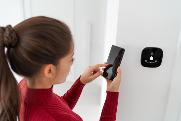 homeowner synching thermostat configuration on phone