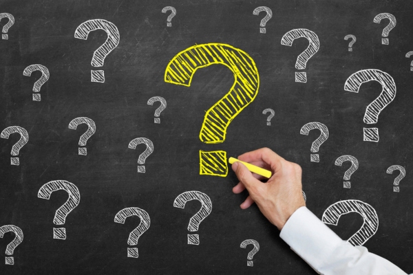 question marks doodled on a chalkboard depicting Oil Heating System Maintenance FAQs