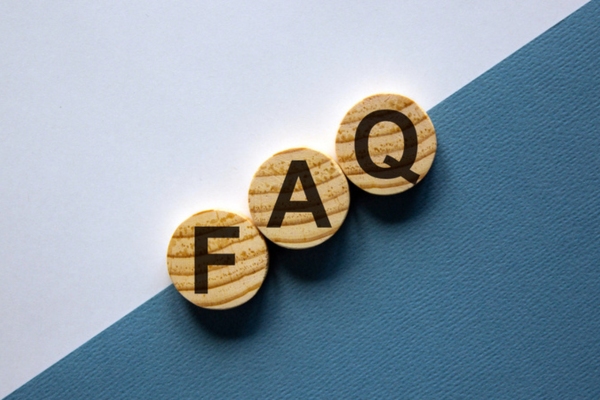 FAQ spelled using circular wooden letter chips depicting Air Conditioner Care questions
