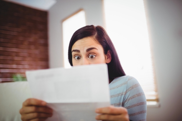 Shocked woman reading latest energy bill