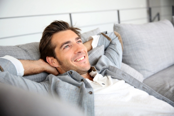man relaxing on a sofa depicting good indoor air quality