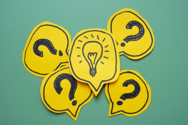 question mark on paper cutouts with idea bulb cutout in the middle depicting Comfort Air Conditioner