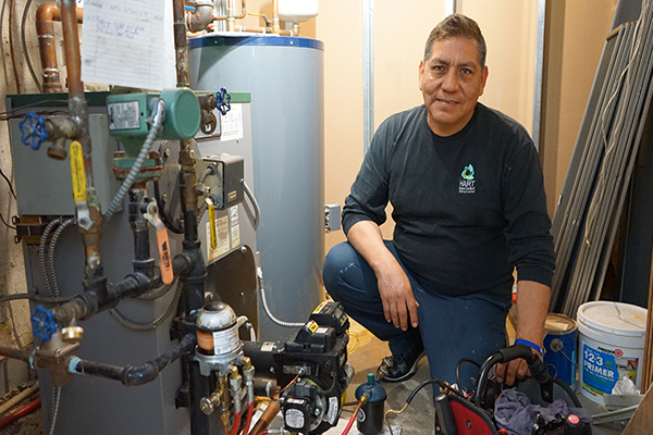 heating technician servicing a home boiler system