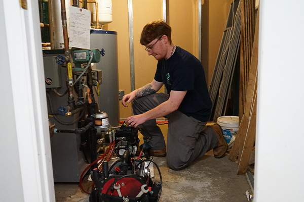 hvac repair technician working on a residential system