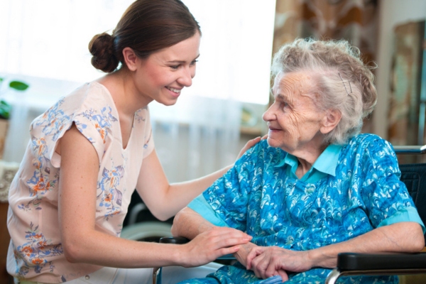 senior woman with home caregiver depicting Air Conditioning Considerations for Sensitive Individuals
