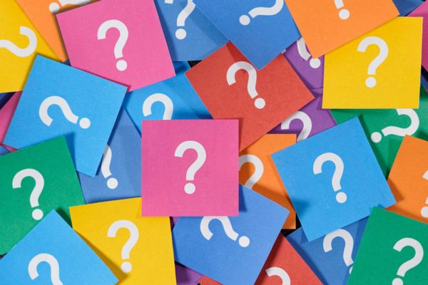 question marks on colored papers depicting Frequently Asked Questions About Lights Flickering When AC Turns On