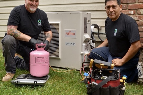 Babylon, NY technicians preparing for air conditioning installation with tools and equipment