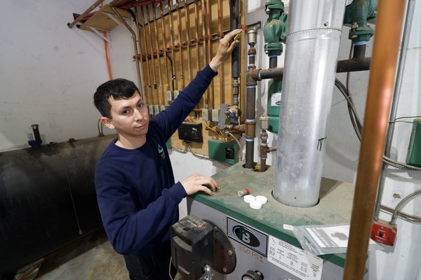 Plainview, NY technician performing boiler repair and service in a residential setting