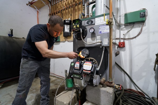 Plainview, NY technician performing service on an oil burner and furnace unit