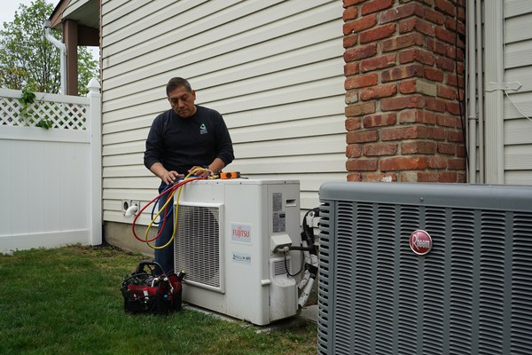 Babylon, NY technician servicing a ductless mini split air conditioning unit