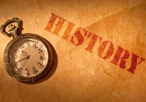 antique watch with history written on brown paper